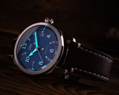 Wristwatch with blue dial and black leather strap on a dark background