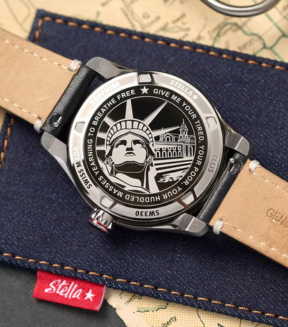 Watch with Statue of Liberty design on a denim surface with Stella brand tag