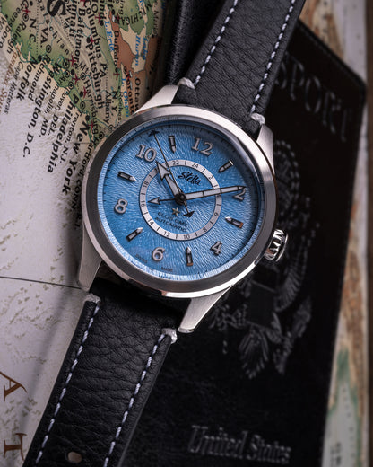 Watch with a blue face and black leather strap on a map background